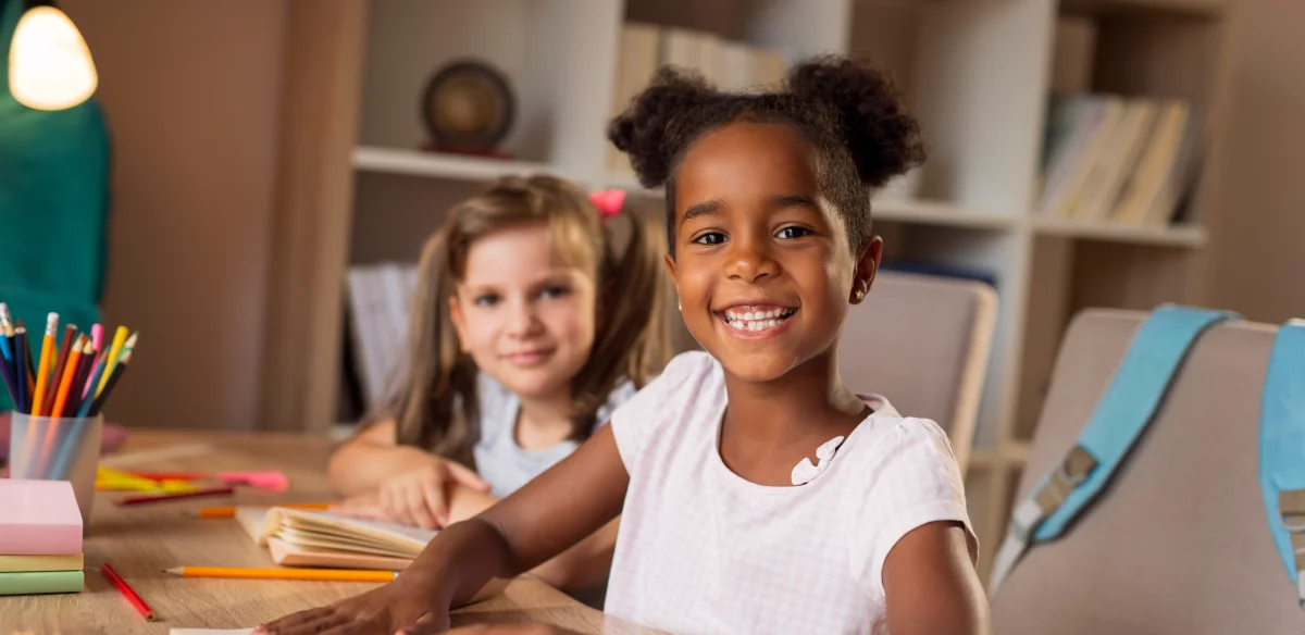 Elementary students smiling at the camera